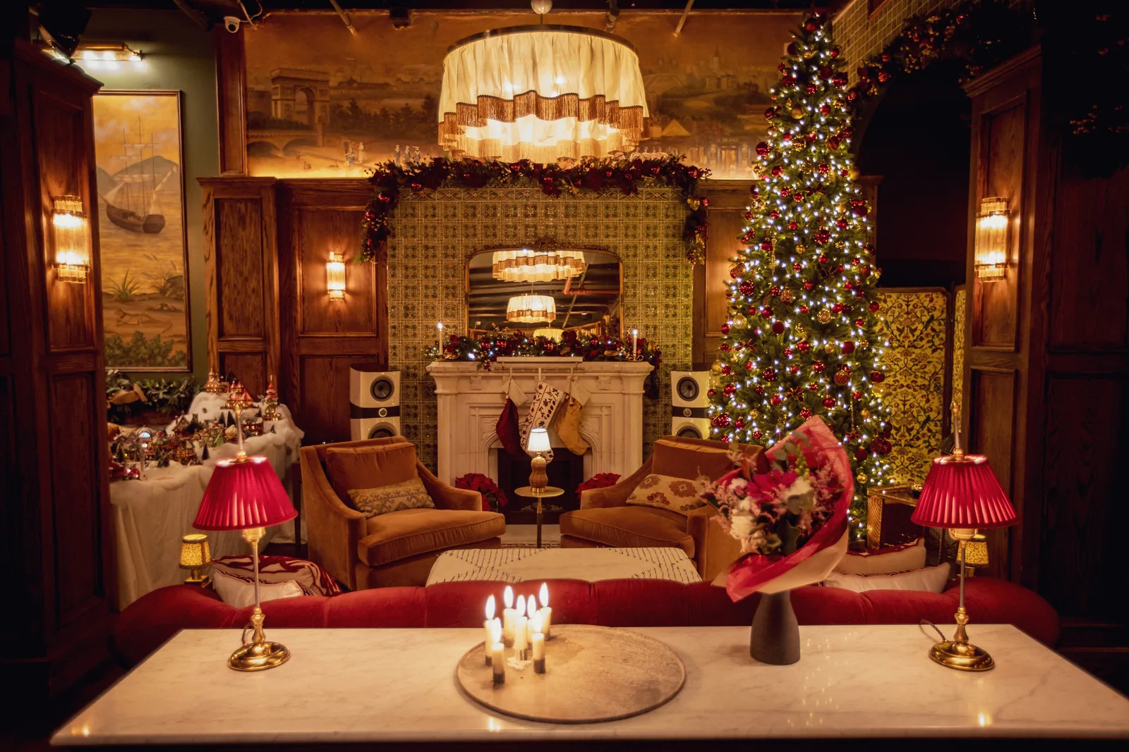 Candlelit fireside lounge at the Maxwell townhouse in Tribeca, dressed with garland and a lit tree