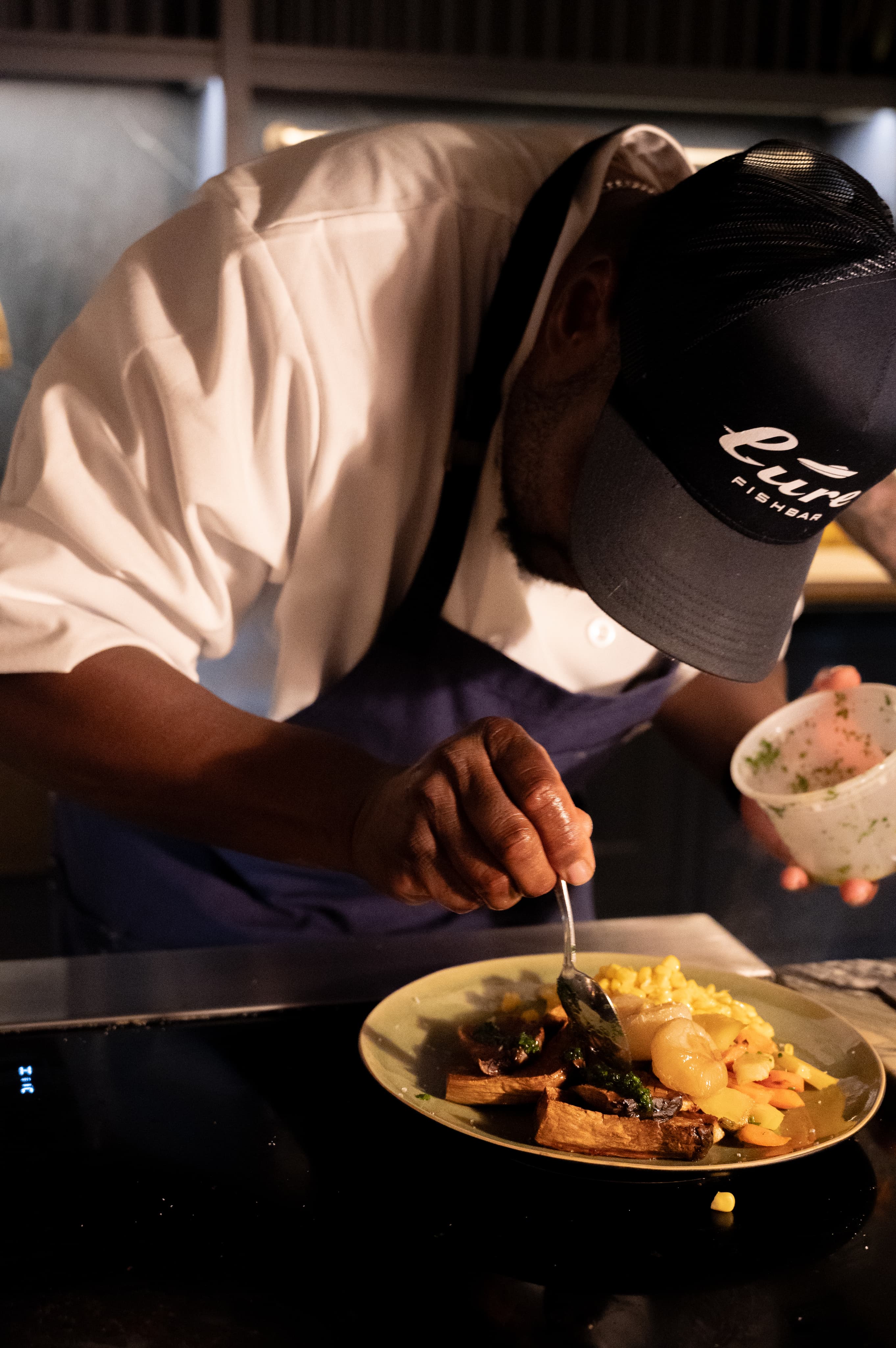 Chef preparing a dish at Maxwell
